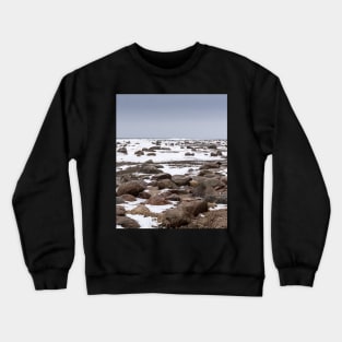 Rocks and snow on the coast of frozen sea Crewneck Sweatshirt